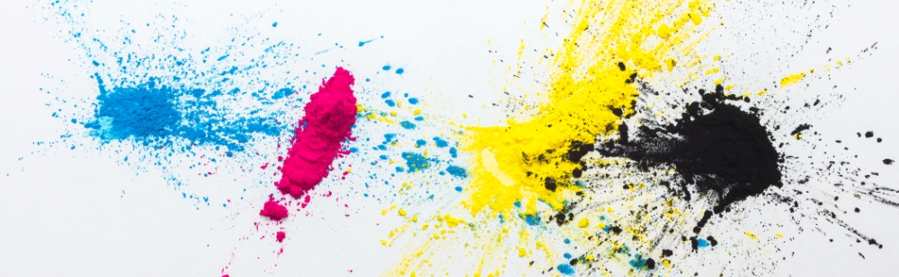 cyan, magenta, yellow, and black printer toner splashed on a canvas